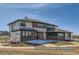 Two story home features modern architecture, a mix of materials, and large windows for lots of light at 9752 Canyon Wind Pt, Parker, CO 80138