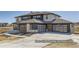 Modern glass garage doors and a wide driveway add curb appeal to this two story home's elevation at 9752 Canyon Wind Pt, Parker, CO 80138