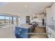 Modern kitchen with a large island, stainless steel appliances, and open concept layout to the living area at 9752 Canyon Wind Pt, Parker, CO 80138