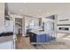 This open kitchen features stainless appliances, a large island, and steps up to the great room at 9752 Canyon Wind Pt, Parker, CO 80138