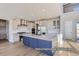 Open kitchen design featuring an island with seating, stainless steel appliances, and white cabinetry at 9752 Canyon Wind Pt, Parker, CO 80138
