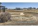 A view of nearby houses, a road, and a sprawling dirt lot creates an interesting visual scene at 9752 Canyon Wind Pt, Parker, CO 80138