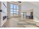 Spacious living area with fireplace, high ceilings, large windows, and open to kitchen at 9752 Canyon Wind Pt, Parker, CO 80138