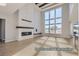 Bright living room with high ceilings, fireplace, and large windows with outside views at 9752 Canyon Wind Pt, Parker, CO 80138