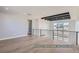 Bright living area boasts wood floors, large windows, and modern railing overlooking the entry at 9752 Canyon Wind Pt, Parker, CO 80138