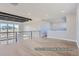 Bright living area boasts wood floors, large windows, and modern railing overlooking the entry at 9752 Canyon Wind Pt, Parker, CO 80138
