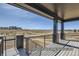 Scenic view from covered patio showcases iron railing and post supports with picturesque scenery at 9752 Canyon Wind Pt, Parker, CO 80138