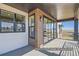 A covered patio featuring a sliding glass door and wood paneling offers outdoor living space at 9752 Canyon Wind Pt, Parker, CO 80138