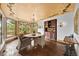 Charming dining room with decorative ceiling, chandelier, and large windows overlooking the surrounding trees at 10231 Democrat Rd, Parker, CO 80134