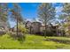 Sprawling two-story home featuring a stone turret, front lawn, lush greenery and professional landscaping at 10231 Democrat Rd, Parker, CO 80134
