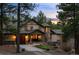 Twilight view of home with stone accents, beautiful lawn, covered entry and three car garage at 10231 Democrat Rd, Parker, CO 80134