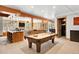 Spacious game room with pool table, fireplace, and wood accents with a view of the surrounding landscape at 10231 Democrat Rd, Parker, CO 80134
