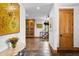 Hallway with decorative painting and stone floors leading to a staircase and other parts of the house at 10231 Democrat Rd, Parker, CO 80134
