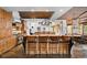 Eat-in kitchen features a granite breakfast bar with seating and a unique brick ceiling at 10231 Democrat Rd, Parker, CO 80134