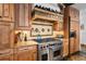 Well-equipped kitchen featuring custom cabinetry, granite countertops, and stainless steel range at 10231 Democrat Rd, Parker, CO 80134