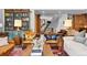 Inviting living room showcasing built-in shelving, comfortable seating, and an open staircase at 10231 Democrat Rd, Parker, CO 80134