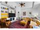 Bright living room features built-in bookshelves, a ceiling fan, and a cozy seating area at 10231 Democrat Rd, Parker, CO 80134