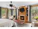 Spacious main bedroom with fireplace, built-ins, large windows, and a ceiling fan at 10231 Democrat Rd, Parker, CO 80134