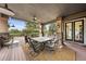 Covered patio features a dining table, comfortable seating, and scenic views of the surrounding landscape at 10231 Democrat Rd, Parker, CO 80134