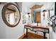 Beautiful powder room with detailed mirror and decorative vanity at 10231 Democrat Rd, Parker, CO 80134