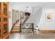 Beautiful and open staircase with decorative artwork and exposed brick at 10231 Democrat Rd, Parker, CO 80134