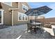 Backyard patio area with dining table and umbrella, ideal for outdoor gatherings at 10597 Casper St, Parker, CO 80134