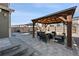 Landscaped backyard patio featuring a pergola with outdoor seating and a built-in fire pit at 10597 Casper St, Parker, CO 80134