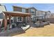 Inviting backyard with a covered patio, outdoor seating, and a built-in fire pit, perfect for entertaining at 10597 Casper St, Parker, CO 80134