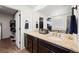 This bathroom showcases a double vanity with granite counters and modern fixtures at 10597 Casper St, Parker, CO 80134