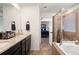 Bathroom features a double vanity, soaking tub, and tiled stand-up shower at 10597 Casper St, Parker, CO 80134