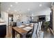 Modern dining room featuring open layout and views into the living room and kitchen at 10597 Casper St, Parker, CO 80134