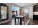 Elegant dining room with a stylish table, contemporary decor, and sliding glass doors to the backyard at 10597 Casper St, Parker, CO 80134