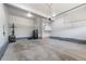 Spacious garage with storage, concrete floors, and an automatic door perfect for parking and hobbies at 10597 Casper St, Parker, CO 80134