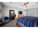 Relaxing main bedroom featuring a plush chair, modern decor, and a glimpse into the ensuite bathroom at 10597 Casper St, Parker, CO 80134