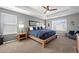 Serene main bedroom with a tray ceiling, comfortable bed, and ample natural light from the windows at 10597 Casper St, Parker, CO 80134
