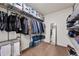 A walk-in closet has built-in shelving, hanging rods, and plenty of storage at 10597 Casper St, Parker, CO 80134