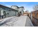 Large backyard with snow-covered ground and a wooden fence at 9094 E 58Th Dr, Denver, CO 80238