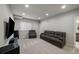 Finished basement includes a comfortable seating area and large TV at 9094 E 58Th Dr, Denver, CO 80238