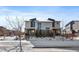 Two-story townhouses with snowy front yards and landscaping at 9094 E 58Th Dr, Denver, CO 80238