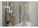 Glass shower with neutral tile and built-in shower caddy at 9094 E 58Th Dr, Denver, CO 80238