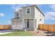 Inviting two-story home featuring a gray exterior, well-kept lawn, and attached two-car garage at 17850 E 94Th Ave, Commerce City, CO 80022