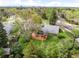 Aerial view of the home with a lush backyard, large wooden deck, and mature trees at 1800 S Niagara Way, Denver, CO 80224
