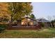 Inviting backyard deck with comfortable seating, dining set, and beautiful landscaping and large arched windows at 1800 S Niagara Way, Denver, CO 80224