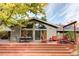 A beautiful backyard and patio with a dining table and outdoor furniture on the wooden deck at 1800 S Niagara Way, Denver, CO 80224