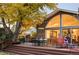 Captivating backyard deck with a dining table set and lounge furniture near the large arched windows at 1800 S Niagara Way, Denver, CO 80224