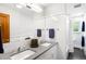 Bathroom features a dual sink vanity with a large mirror and shower with glass enclosure at 1800 S Niagara Way, Denver, CO 80224