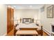 Comfortable bedroom with a classic wooden bed frame, soft bedding, and ample natural light at 1800 S Niagara Way, Denver, CO 80224