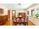 Elegant dining room with hardwood floors, a large table, and a window with natural light at 1800 S Niagara Way, Denver, CO 80224