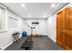 Well-lit exercise room with a workout bench, exercise equipment, and a wall-mounted workout guide at 1800 S Niagara Way, Denver, CO 80224