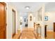 Inviting foyer features hardwood floors, elegant lighting, and an open floor plan with views to the living spaces at 1800 S Niagara Way, Denver, CO 80224